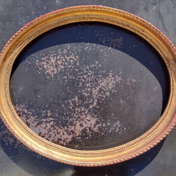 Vintage oval frame with old gold patina, empty frame