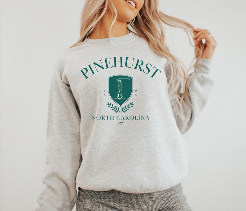 May include: Gray sweatshirt with a green graphic of a golfer and the text "Pinehurst 1895 North Carolina golf"