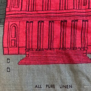 May include: A red and gray linen fabric with a black and white illustration of a building with columns. The fabric has the text "ALL PURE LINEN" printed on it.