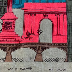 May include: A colorful illustration of a bridge with an archway and a building with a column. The image is printed on a gray linen fabric with the text "MADE IN IRELAND" and "FAST COLOURS" at the bottom.