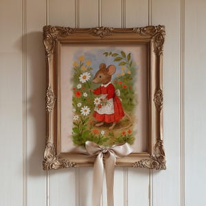 May include: A framed artwork featuring a charming illustration of a mouse in a red dress and white apron, holding daisies in a colorful garden setting. The ornate gold frame is adorned with a beige bow.