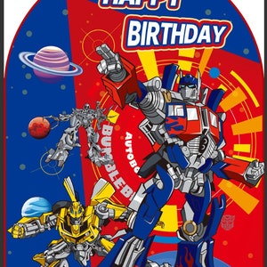 May include: A rectangular Transformers birthday sign featuring Optimus Prime and Bumblebee in a space setting with planets. The text HAPPY BIRTHDAY is printed at the top in bold white letters with a red outline. The background is red and blue.