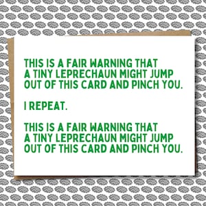 May include: A white card with green text that reads "This is a fair warning that a tiny leprechaun might jump out of this card and pinch you. I repeat. This is a fair warning that a tiny leprechaun might jump out of this card and pinch you."
