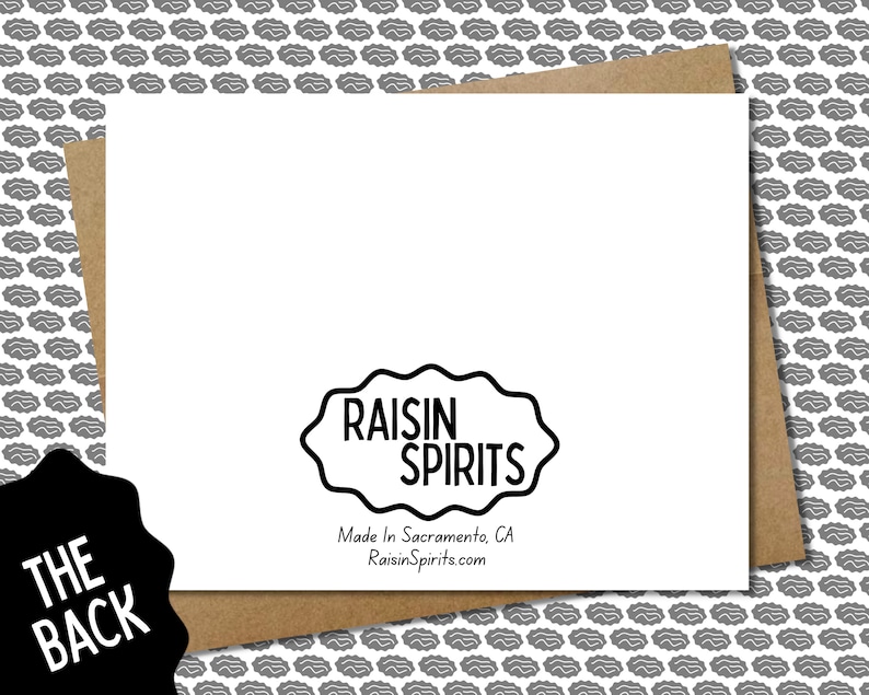 May include: The back of a white greeting card with the text "RAISIN SPIRITS" in a black, wavy-edged cloud shape. Below the logo is "Made In Sacramento, CA RaisinSpirits.com". The card is on a brown envelope, with a gray pattern background.