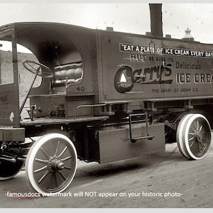 May include: A black and white photo of an old ice cream truck with the words "Carry's Ice Cream" and "Eat a plate of ice cream every day" on the side.