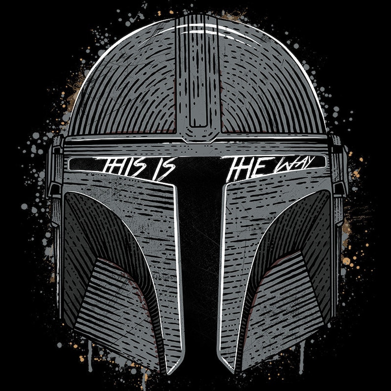 May include: A black and white illustration of a Mandalorian helmet with the text "This is the way" across the visor. The helmet is surrounded by a splatter of paint.