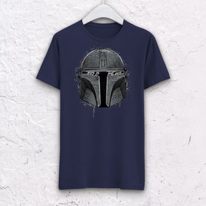 May include: A navy blue t-shirt with a white graphic of a Mandalorian helmet with the text "This is the way" on it.