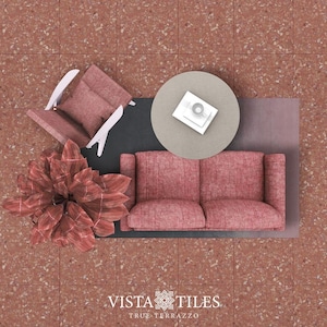 Puede incluir: Vista desde arriba de una sala de estar con un sofá rosa, un sillón rosa, una mesa de café redonda y una planta en maceta. El suelo está cubierto de baldosas de terrazo rojo. El texto "Vista Tiles True Terrazzo" es visible en la esquina inferior derecha de la imagen.