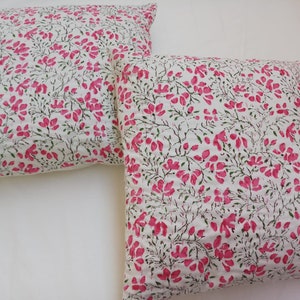 May include: Two white pillowcases with a pink floral pattern. The pillowcases are made of cotton and have a soft, comfortable feel.