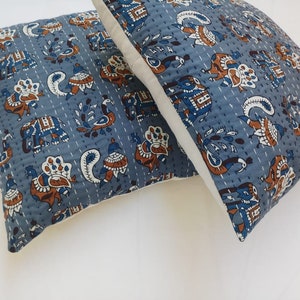 May include: Two blue and white patterned pillow covers with a white border. The pattern features peacocks, elephants, and paisley designs.
