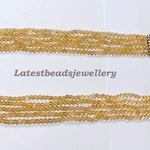 May include: A multi-strand necklace made of light brown beads with silver end caps and a silver chain closure. The necklace is on a white background. Latestbeadsjewellery is printed in black text on the background.