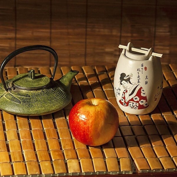 Still life Japanese style Green Teapot Red Apple Aroma Lamp With a Picture of a Geisha Color Photo Digital Photo