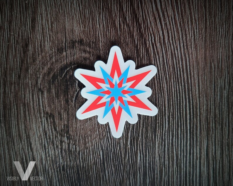 May include: A white sticker with a red and blue starburst design. The starburst has a white border and is centered on a dark brown wooden surface. The text "VISIBLY VECTOR" is in the bottom left corner.