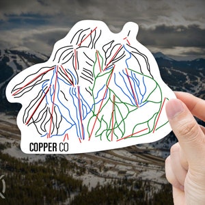 May include: A white sticker with a black, blue, green, and red outline of a ski resort map. The text "COPPER CO" is printed in black at the bottom of the sticker.
