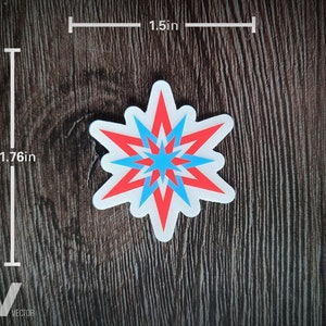 May include: A sticker with a starburst design in red and blue, outlined in white. The sticker measures 1.76 inches tall and 1.5 inches wide. The sticker is on a dark wood grain surface.