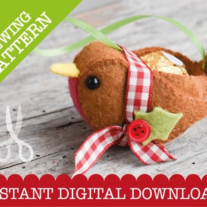 May include: A felt sewing pattern for a Christmas robin ornament. The robin is brown with a red and white checkered ribbon around its neck. The robin has a yellow beak and black eyes. The robin is holding a chocolate candy in its belly. The pattern includes instructions for sewing the robin and adding the candy.