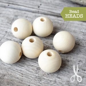 May include: Six natural wood beads with a hole in the centre. Bead Heads is written in a green rectangle at the top of the image.