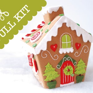 May include: A felt gingerbread house craft kit with a red door, green trees, and candy decorations. The kit includes all the materials needed to make the house, including felt, thread, and buttons.  Full Kit.