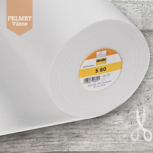 May include: A roll of white fabric with a yellow and orange label that reads "Vlieseline S 80". The fabric is 30 cm x 25 m. The brand name "PELMET Vilene" is printed on the upper left corner.