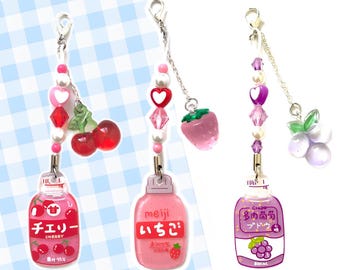 May include: Three charm necklaces with colorful fruit-themed charms and miniature juice bottles. The charms include a red cherry, a pink strawberry, and a purple grape. The juice bottles are labeled "Cherry", "Strawberry", and "Grape".
