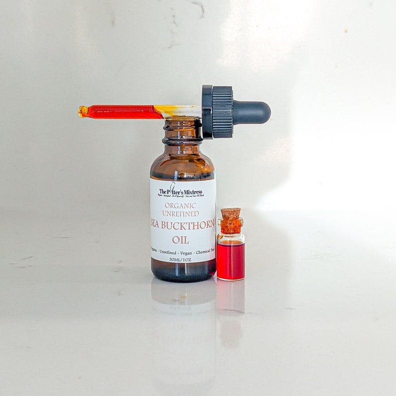 May include: A brown glass bottle with a dropper filled with organic unrefined sea buckthorn oil. The bottle is labeled "The Pilter's Mistress" and "Organic Unrefined Sea Buckthorn Oil". The bottle is 30 ml/1 oz.