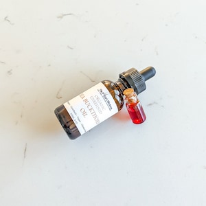 May include: A brown glass bottle with a dropper top containing organic unrefined sea buckthorn oil. The bottle is labeled with the text "The Pifter's Mistres Organic Unrefined Sea Buckthorn Oil" and "30ML/1 OZ".