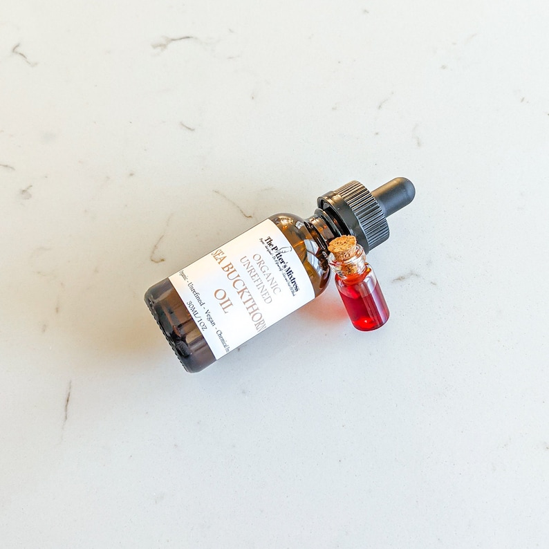 May include: A brown glass bottle with a dropper top containing organic unrefined sea buckthorn oil. The bottle is labeled with the text "The Pifter's Mistres Organic Unrefined Sea Buckthorn Oil" and "30ML/1 OZ".