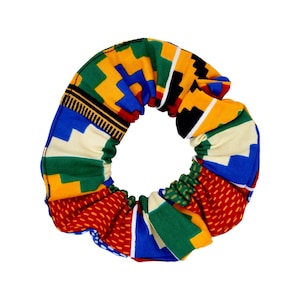 May include: A colorful hair scrunchie with a geometric pattern in shades of red, yellow, blue, green, and white.