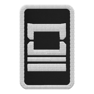 May include: Embroidered patch with a black rectangular design featuring a white border and white horizontal lines. The patch has a rectangular shape with rounded corners. The design is a stylized letter or symbol.