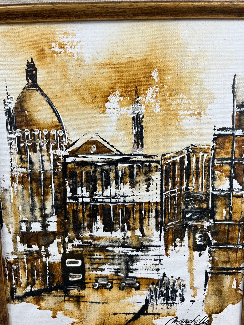 May include: A painting of a city scene in shades of brown, black, and white. The painting features a tall building with a dome on top, and several other buildings in the background. The painting is signed "Marcelle" in the bottom right corner.