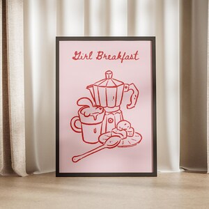 May include: A pink poster with the text "Girl Breakfast" in red lettering. The poster features a line drawing of a coffee pot, a cup, a spoon, and some pastries.
