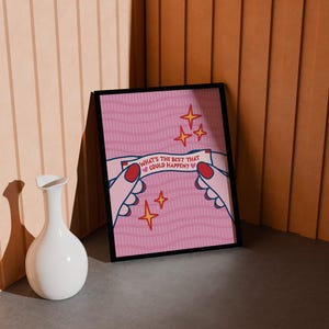 Peut inclure: Une affiche rose encadr&eacute;e avec le texte "WHAT'S THE BEST THAT COULD HAPPEN ?" tenue par des mains de dessin anim&eacute; avec des ongles rouges. L'affiche a un motif ondul&eacute; et des &eacute;toiles dor&eacute;es. Un vase blanc est devant.