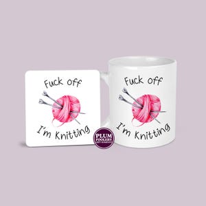 11oz ceramic mug in all white with an optional white MDF matching coaster. It has the words “Fuck off I’m knitting” with an illustration of a pink ball of yarn with knitting needles. mug is microwave & dishwasher safe.