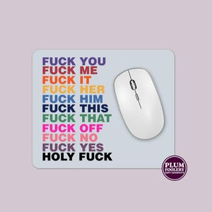 May include: A rectangular mousepad with the words "FUCK YOU, FUCK ME, FUCK IT, FUCK HER, FUCK HIM, FUCK THIS, FUCK THAT, FUCK OFF, FUCK NO, FUCK YES, HOLY FUCK" in various colours. A white wireless mouse is on the right. The Plum Foolery Gift Company logo is in the bottom right.