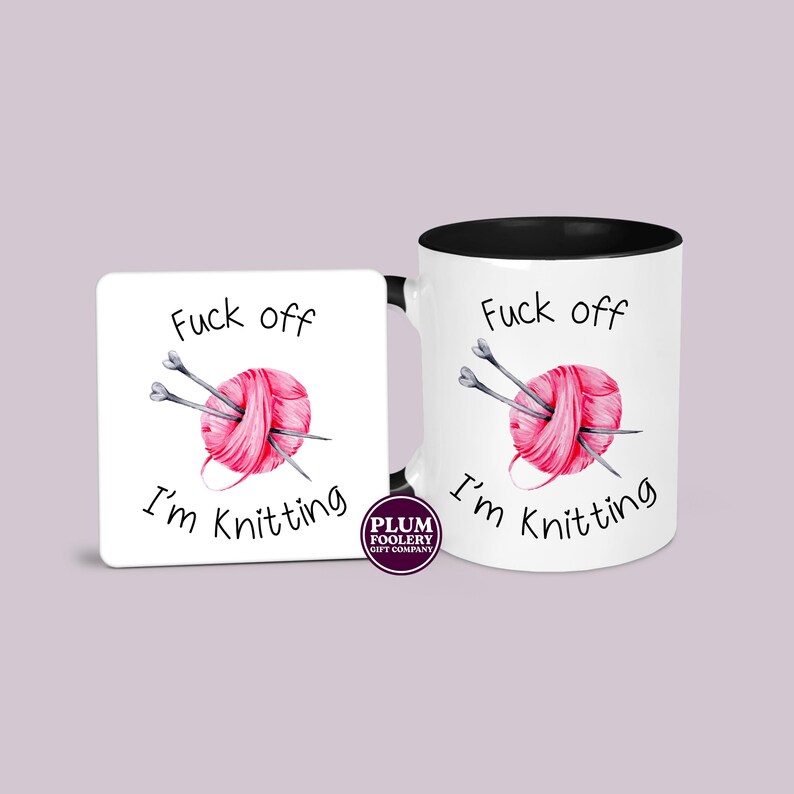 11oz ceramic mug in white with black accents and an optional white MDF matching coaster. It has the words “Fuck off I’m knitting” with an illustration of a pink ball of yarn with knitting needles. mug is microwave & dishwasher safe.