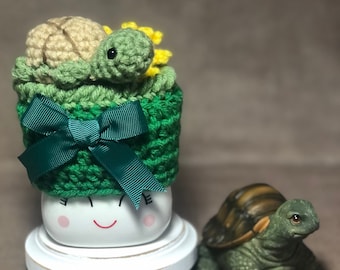 Crocheted Marshmallow Mug Hat- “Tortoise On Grass With A Dandelion”