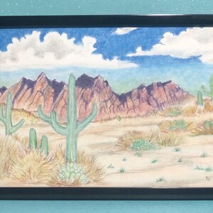 May include: A watercolor painting of a desert landscape with mountains in the background and a large cactus in the foreground. The sky is blue with white clouds. The mountains are a reddish-purple color. The cactus is green and has many arms. The ground is a light brown color.