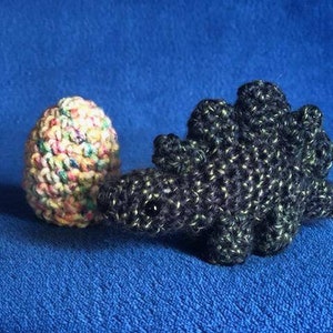 Crocheted Mini Dinosaur, Stegosaurus, With A Crocheted Speckled Colored Egg