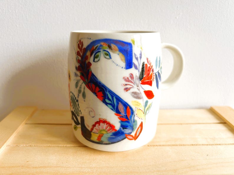 Vintage Petal Palette mug designed by American fine artist, Starla M Halfmann for Anthropologie. The letter "S" entwined in beautiful flowers.