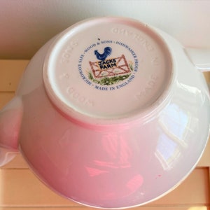 May include: White ceramic teapot with a rooster and farm scene on the bottom. The text reads "Microwave Safe - Wood & Sons - Dishwasher Proof - Made in England - Jacks Farm".