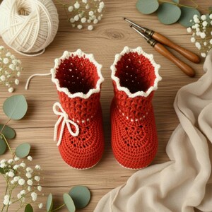 Close-up of crochet baby booties showing detailed stitches and soft yarn texture.