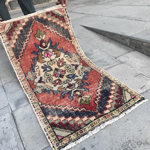 Könnte beinhalten: Ein vintage türkischer Teppich mit einem geometrischen Muster in Rot, Blau und Weiß. Der Teppich hat einen Fransenrand und ist in gutem Zustand.