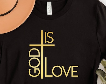 May include: Black t-shirt with a gold cross and the text "God is Love" printed on the front.