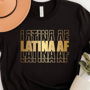 May include: Black t-shirt with gold lettering that reads "Latina AF" repeated three times.
