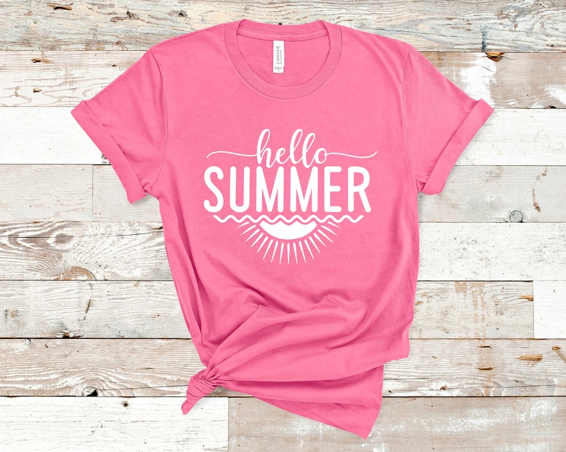 May include: Pink t-shirt with the text "hello summer" in white, with a stylized sun and waves underneath.