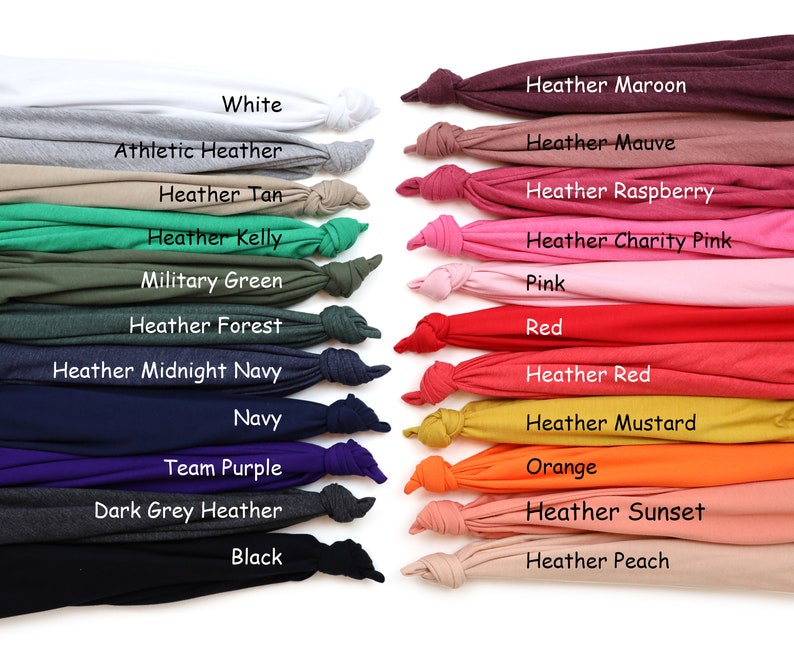 May include: A display of folded t-shirts in a variety of colours, including white, grey, green, navy, red, and orange. Each shirt is labelled with its colour name, such as "White," "Navy," and "Orange." The shirts are arranged in rows, showcasing a wide range of hues.