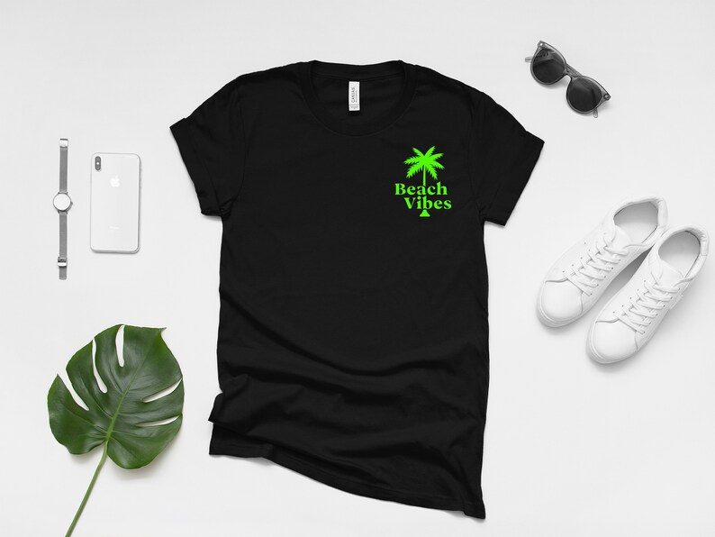May include: Black t-shirt with a green palm tree and the text "Beach Vibes" on the front.