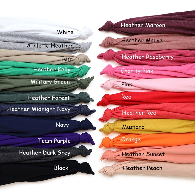 May include: A color chart displaying various fabric swatches, each knotted at the end. The swatches showcase a range of colors, including white, gray, tan, green, navy, purple, and black, along with shades like pink, red, orange, and peach. Each swatch is labeled with its color name.
