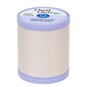 May include: A spool of off-white Dual Duty XP thread for paper piecing. The spool features a light purple plastic top and bottom cap. The label displays the text Dual Duty XP, Paper Piecing, Coats, 225 yds, 205 m, and Mexico.