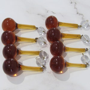 May include: Ten amber glass teardrop chandelier crystals with clear glass beads and gold metal accents.